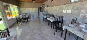 a restaurant with tables and chairs in a room at Hame Lana Resort in Mawlynnong
