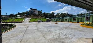 a large parking lot with a building in the background at Hame Lana Resort in Mawlynnong