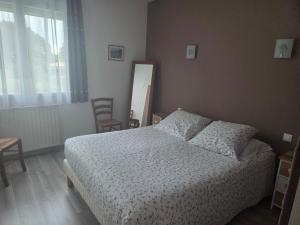 a bedroom with a bed and a mirror and a window at Maison en Béarn in Ogeu-les-Bains