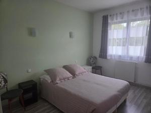 a bedroom with a bed and a window at Maison en Béarn in Ogeu-les-Bains