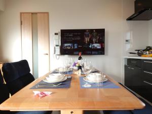 a dining room table with wine glasses on it at GLANZ KEI Kyoto Station in Kyoto