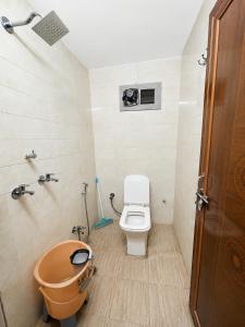 a bathroom with a toilet and a sink and a tub at Inka Kashi Hostel Varanasi in Varanasi +45 photos