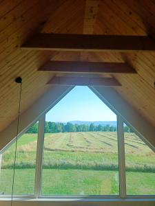 a window in a room with a view of a field at Zielone Wzgórze komfortowy klimatyzowany domek z balią z aeromasażem in Kłodzko +93 photos