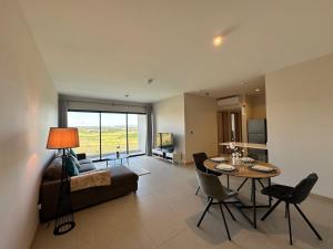 a living room with a table and a couch at Verdant Horizon in Moka