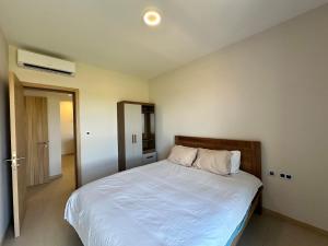 a bedroom with a large bed with white sheets at Verdant Horizon in Moka