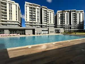 a swimming pool in front of two tall buildings at Verdant Horizon in Moka +8 photos