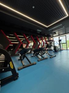 a gym with a row of treadmills and machines at The New Jai Son in Kobuleti