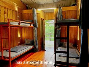 a room with three bunk beds and a window at Hahaland in Phong Nha +105 photos