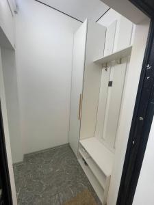 a white cabinet in a kitchen with a floor at Diamond resort in Bosteri