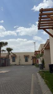 a building with a brick driveway in front of it at بالم هيلز Palm Hills in Baljurashi