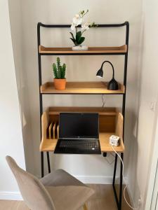 a desk with a laptop computer on a shelf at Studio Chic & Balcon - Hypercentre - Gare - Metro in Toulouse