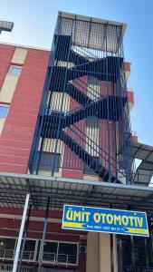 a building with a bird cage on the side of it at Barış hotel in Alasehir +8 photos