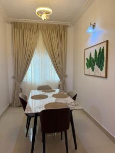 a dining room with a table and chairs at Was Homes in Abuja