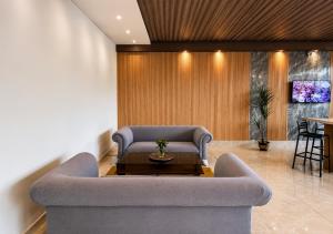 a living room with a couch and a table at Paradise Resort Langkawi in Pantai Cenang