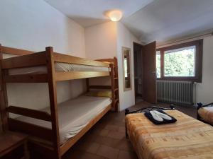 a bedroom with two bunk beds and a window at Setcases-Vallter hostal Mitja Pensió 2 in Setcases