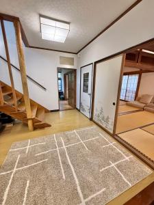 a living room with a rug on the floor at Kuro House Myoko in Myoko
