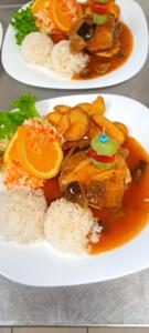 two plates of food on a table with rice at BUBO Penzion & Restaurant in Moravany