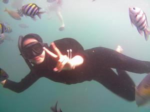 a man in a diver suit swimming in the water at Taba Yama Trip & Homestay in Ketapang +50 photos