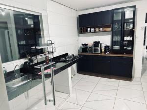 a kitchen with a sink and a counter top at Recanto JF in Pirapora