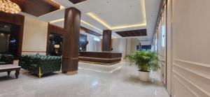 a lobby with a waiting room with a couch and a chair at The Vaishnavi Hotel , Buxar Bihar in Buxar