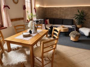a living room with a table and chairs and a couch at Apartmany Ruby in Rokytnice nad Jizerou