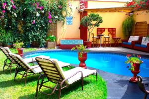 a patio with chairs and a swimming pool at Peru Star Apart-Hotel in Lima
