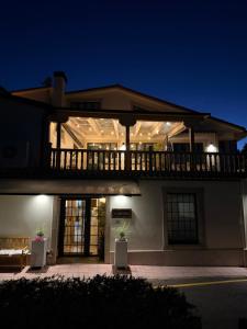 a large white building with a balcony on top of it at A TABERNA ROOMS in Laracha