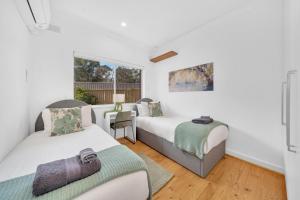 a bedroom with two beds and a window at 11 Guests 6BR, Granny Flat, 3 Kitchens, Hiking in Dernancourt