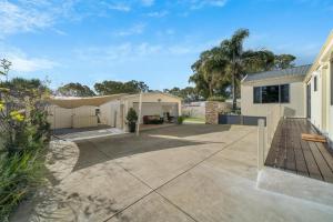 a house with a patio and a fence at 11 Guests 6BR, Granny Flat, 3 Kitchens, Hiking in Dernancourt