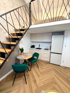a kitchen with a table and chairs and a staircase at The Emerald Loft I Terrace I Free Parking in Kaunas