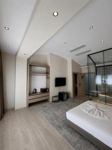 a bedroom with a bed and a flat screen tv at İstanblu Hotel&Spa in Konak