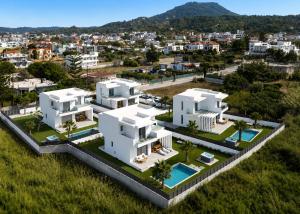 an aerial view of two white houses in a city at Martini Villas in Kremasti