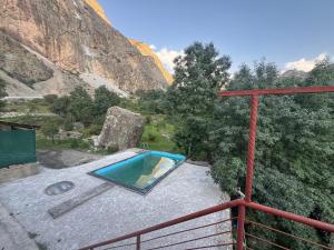 a swimming pool in the middle of a mountain at Sharsharai Haftkul in Panjakent +14 photos