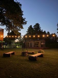 a building with lights and benches in a field at Jaunmāriņi in Liepāja