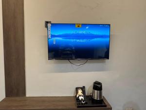 a flat screen tv hanging on a wall at Velenburg Retreat in Upper Topa