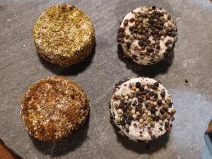 four donuts with sprinkles on top of a pan at Abries Hôtel in Abriès