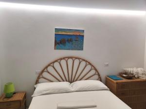 a bedroom with a bed and a painting on the wall at VisitPonza - Le Naiadi in Ponza
