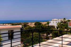 a balcony with a view of the ocean at Kensington Villa - Private Pool & Rooftop Terrace by Azur Prime in Ayios Yeoryios