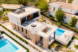 an aerial view of a house with a swimming pool at Kensington Villa - Private Pool & Rooftop Terrace by Azur Prime in Ayios Yeoryios