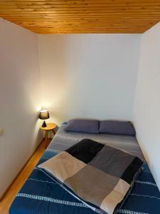 a bed in a bedroom with a wooden ceiling at Casa Baciului,Cluj-Napoca in Cluj-Napoca