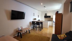 a living room with a couch and a table and a kitchen at Schubert's in Bruckneudorf +5 photos