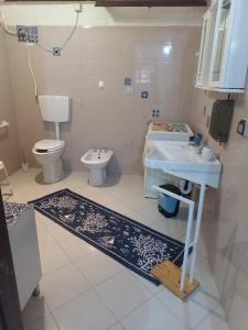 a bathroom with a sink and a toilet at Green House in Briatico