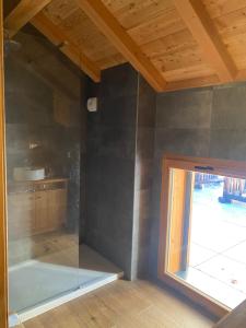 a glass shower in a room with a window at Chalet Chante Guisane in Saint-Chaffrey +31 photos