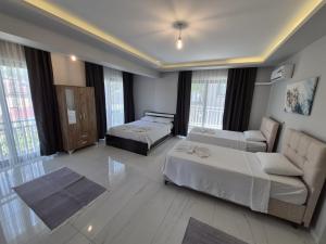 a living room with two beds and a couch at Villa Kaya Maris Göcek in Fethiye