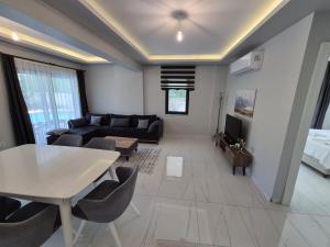 a living room with a couch and a table at Villa Kaya Maris Göcek in Fethiye