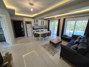 a living room with a couch and a table at Villa Kaya Maris Göcek in Fethiye