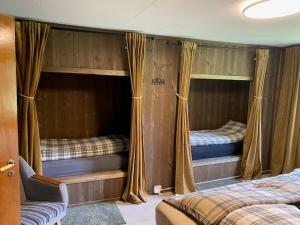 a room with two bunk beds in a house at Nordgården in Handeland