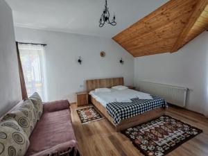 a bedroom with a bed and a couch at Maramures Landscape in Moisei +162 photos