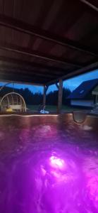 a purple pool of water with a table in it at Dom Na Chwilę in Brzozowa