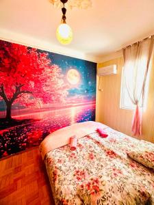 a bedroom with a tree mural on the wall at Budget Home in Kutaisi +24 photos